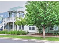 A contemporary two-story exterior featuring wood-grain siding and well-maintained landscaping and healthy trees at 2809 Syracuse Ct # 129, Denver, CO 80238