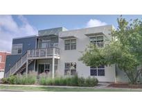 Contemporary home with multiple levels, a small balcony, and fresh landscaping at 2809 Syracuse Ct # 129, Denver, CO 80238
