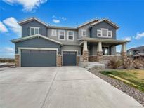 Beautiful two-story home with a three-car garage, stone accents and inviting front porch at 11650 Lewiston Ct, Commerce City, CO 80022