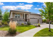 Beautiful home featuring a well-manicured lawn, covered porch, and a three car garage at 26143 E Fremont Pl, Aurora, CO 80016