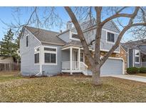 Charming home featuring a two-car garage and appealing stone and blue siding accents at 2358 Dogwood Cir, Louisville, CO 80027