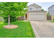 Charming two-story home with a well-manicured lawn and a large tree in the front yard at 5532 S Valdai Way, Aurora, CO 80015