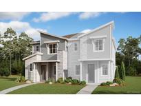 A modern two-story townhome featuring stone and lap siding, a well-manicured lawn, and an attached two-car garage at 22813 E Tufts Ave # A, Aurora, CO 80015