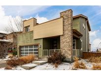 Two-story modern home with stone accents and a large garage at 10081 Truckee St, Commerce City, CO 80022
