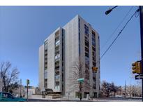 Striking building exterior featuring a modern design with balconies against a bright blue sky backdrop at 777 Washington N St # 802, Denver, CO 80203