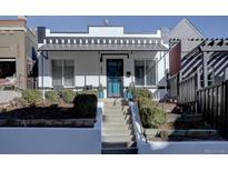 Charming two-story home with a landscaped front yard and black and white color scheme at 1825 W 32Nd Ave, Denver, CO 80211