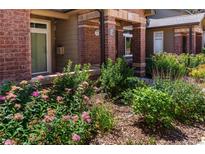 Brick building exterior with well-manicured landscaping and walkway at 6424 Silver Mesa Dr # C, Highlands Ranch, CO 80130