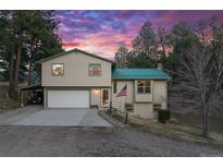 Charming two-story home with a two-car garage, car port, and manicured lawn at 34480 Pine Ridge Cir, Elizabeth, CO 80107