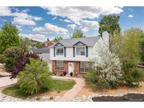 Charming two-story home featuring brick accents, a lush front yard, and a welcoming entrance at 1200 Butterfield Ln, Castle Rock, CO 80104