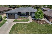 Charming single-story home featuring a landscaped front yard and a modern gray brick exterior at 4930 Gray St, Denver, CO 80212