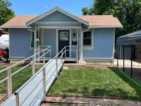 Charming single-story home featuring a ramp, blue siding, and well-maintained lawn at 1738 Dallas St, Aurora, CO 80010