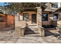 Brick home with a classic porch and steps, offering curb appeal at 1155 Garfield St, Denver, CO 80206