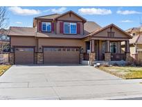 Charming two-story home with a three car garage, covered porch, and well-maintained landscaping at 18130 Bolero Dr, Parker, CO 80134
