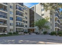 A low angle view of the building's facade shows the entryway, address, and first few stories at 13850 E Marina Dr # 506, Aurora, CO 80014