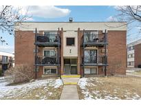 Brick apartment building with balconies and a well-maintained lawn at 5995 W Hampden Ave # 5I, Denver, CO 80227