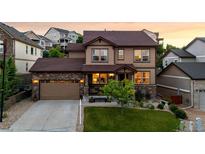Charming two-story home features a well-manicured lawn, stone accents, and an attached two-car garage at 2575 Mccracken Ln, Castle Rock, CO 80104
