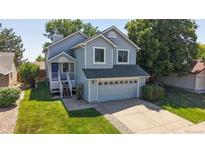 Charming two-story home with inviting front porch and well-maintained lawn at 3755 Shefield Dr, Broomfield, CO 80020
