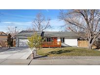 Ranch style home with a remodeled exterior, new landscaping, and a spacious driveway at 6749 Ingalls St, Arvada, CO 80003