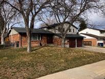 Charming brick home featuring a two-car garage and mature trees in a well-maintained yard at 9325 Meade St, Westminster, CO 80031