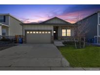 Charming single Gathering home featuring an attached two car garage and beautiful landscaping at 98 Chipeta Way, Lochbuie, CO 80603