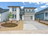 Modern two-story home with a two-car garage, manicured front yard, and a combination of brick and gray siding at 8346 Cokedale Cir, Littleton, CO 80125