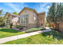 Charming home with stone accents, well-maintained lawn, and inviting walkway at 14333 E Napa Pl # 5D, Aurora, CO 80014
