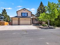 Charming two-story home with a three-car garage, well-maintained landscaping, and a welcoming front porch at 2957 W Rowland Ave, Littleton, CO 80120