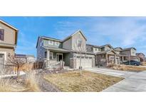 Beautiful two-story home featuring a two-car garage, manicured lawn, and inviting curb appeal at 1066 S Eaton Park Ct, Aurora, CO 80018