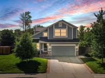 Charming two-story home with a well-maintained lawn and attached two-car garage at 11578 Clayton St, Thornton, CO 80233