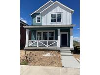 Charming two-story home with a modern color scheme and inviting front porch at 725 Cottonwood Ave, Bennett, CO 80102