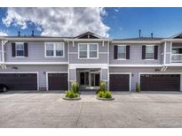 Charming townhome featuring neat landscaping, covered entryway and attached garages at 17225 Lark Water Ln # C, Parker, CO 80134