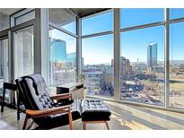 Relaxing living room with city views and hardwood floors at 1700 Bassett St # 1008, Denver, CO 80202