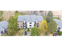 Aerial shot of condominiums with landscaping and parking lot on a sunny day in a desirable location near a river at 6505 Kalua Rd # 204B, Boulder, CO 80301