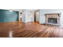 A spacious living room features hardwood floors, a fireplace, and seamlessly connects to the kitchen for entertaining at 6505 Kalua Rd # 204B, Boulder, CO 80301