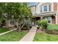 Charming townhome exterior with a well-manicured lawn and inviting front entrance at 9620 W Chatfield Ave # D, Littleton, CO 80128