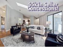 Bright living room with modern decor, hardwood floors, and natural light from sliding glass door at 5690 W 80Th Pl # 101, Arvada, CO 80003