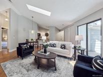 Bright living room features a skylight, contemporary furnishings, and open-concept layout at 5690 W 80Th Pl # 101, Arvada, CO 80003