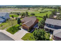 Stunning aerial view of home, showcasing impeccable landscaping and neighboring open space at 1294 Kittery St, Castle Rock, CO 80104