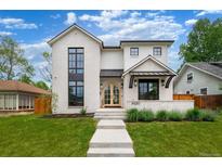Beautifully designed two-story home with a manicured lawn and modern architectural details at 1620 S Ogden St, Denver, CO 80210