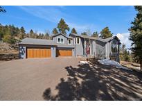 Stunning two-story home with a three-car garage and beautiful landscaping at 6637 Berry Bush Ln, Evergreen, CO 80439