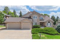 Beautiful two-story home featuring a three car garage and well-maintained landscaping at 20886 Parliament Pl, Parker, CO 80138