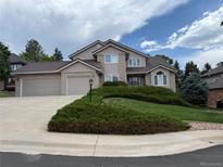 Charming two-story home with a well-manicured lawn and attached two car garage at 20886 Parliament Pl, Parker, CO 80138