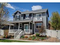 Charming two-story home featuring a welcoming front porch, a second story balcony and professionally landscaped front yard at 629 Jackson St, Lafayette, CO 80026