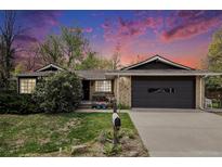 Charming single-story home with a well-manicured lawn and a two-car garage beneath a dramatic evening sky at 4740 Lee Cir, Boulder, CO 80303