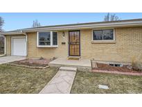 Charming brick home featuring a welcoming front door, bay window, and well-maintained landscaping at 4534 W 65Th Ave, Arvada, CO 80003
