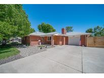 Brick ranch home with attached garage and landscaped yard at 6076 S Valleyview St, Littleton, CO 80120