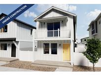 Charming two-story home with a balcony, a white picket fence and a welcoming yellow door at 13161 E 103Rd Pl, Commerce City, CO 80022