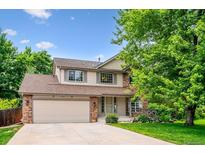 Charming two-story home with a well-manicured lawn and a two car garage, perfect for suburban living at 5721 S Jellison St, Littleton, CO 80123