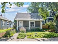 Charming home featuring a covered front porch and lovely landscaping at 3968 Winona Ct, Denver, CO 80212