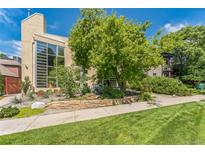 Modern home features a large window and lush landscaping, creating a beautiful curb appeal at 461 Fillmore St, Denver, CO 80206